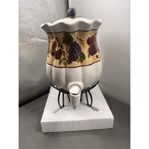 Celebrating Home Stoneware Collection Beverage Dispenser on Wrought Iron stand.